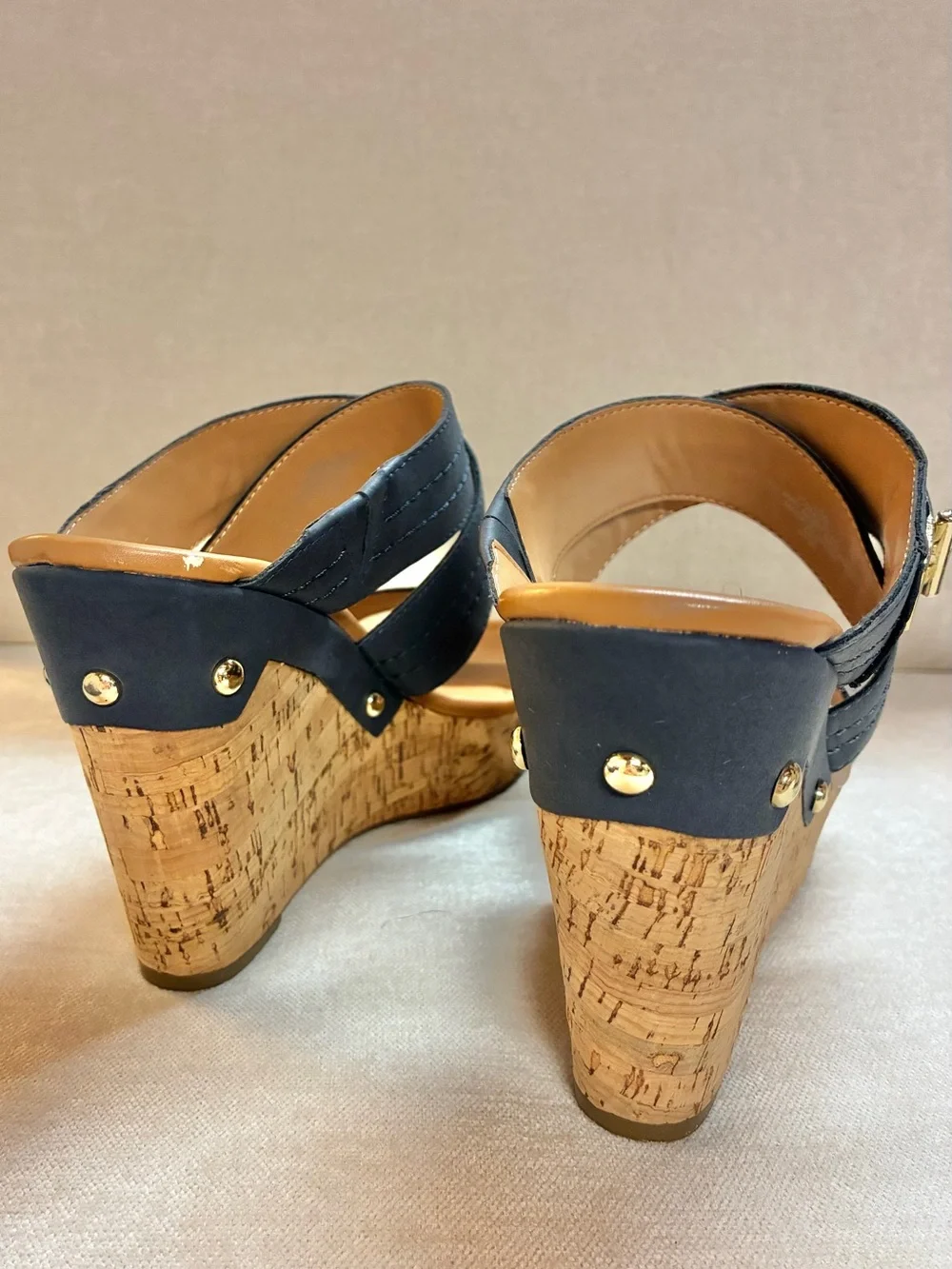 Tommy Hilfiger women’s cork wedge slide sandals with gold-tone logo hardware
